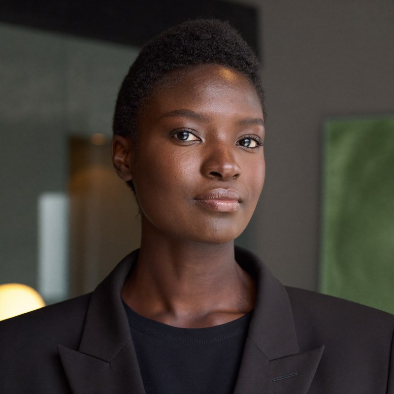 Black woman in a dark blazer, seeking promotion